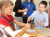 Vaikai kepė draugystės pyragą, kvepiantį obuoliais